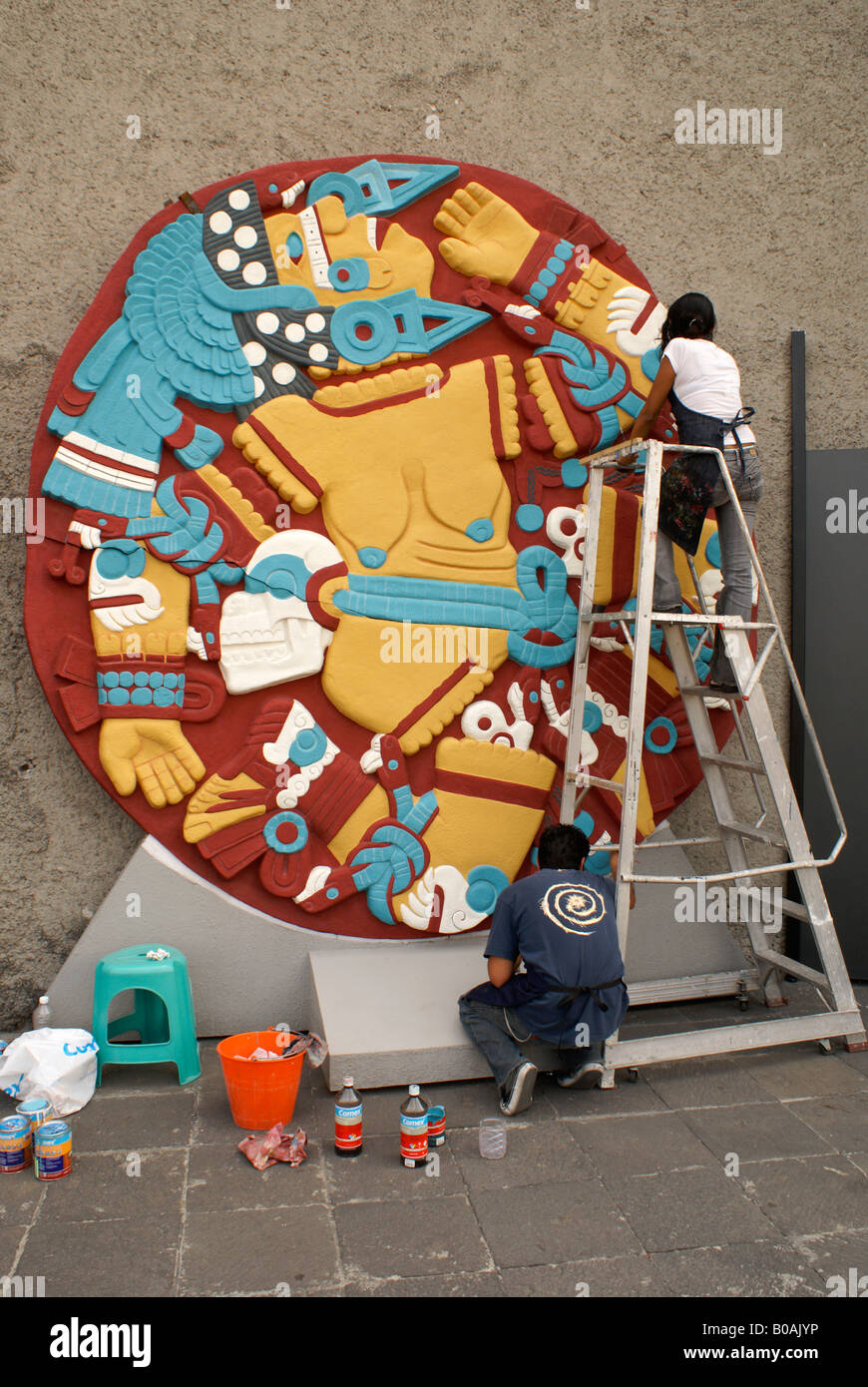 Painters working on replica of stone showing dismembered Aztec goddess Coyolxauhqui, Museo del Templo Mayor, Mexico City Stock Photo