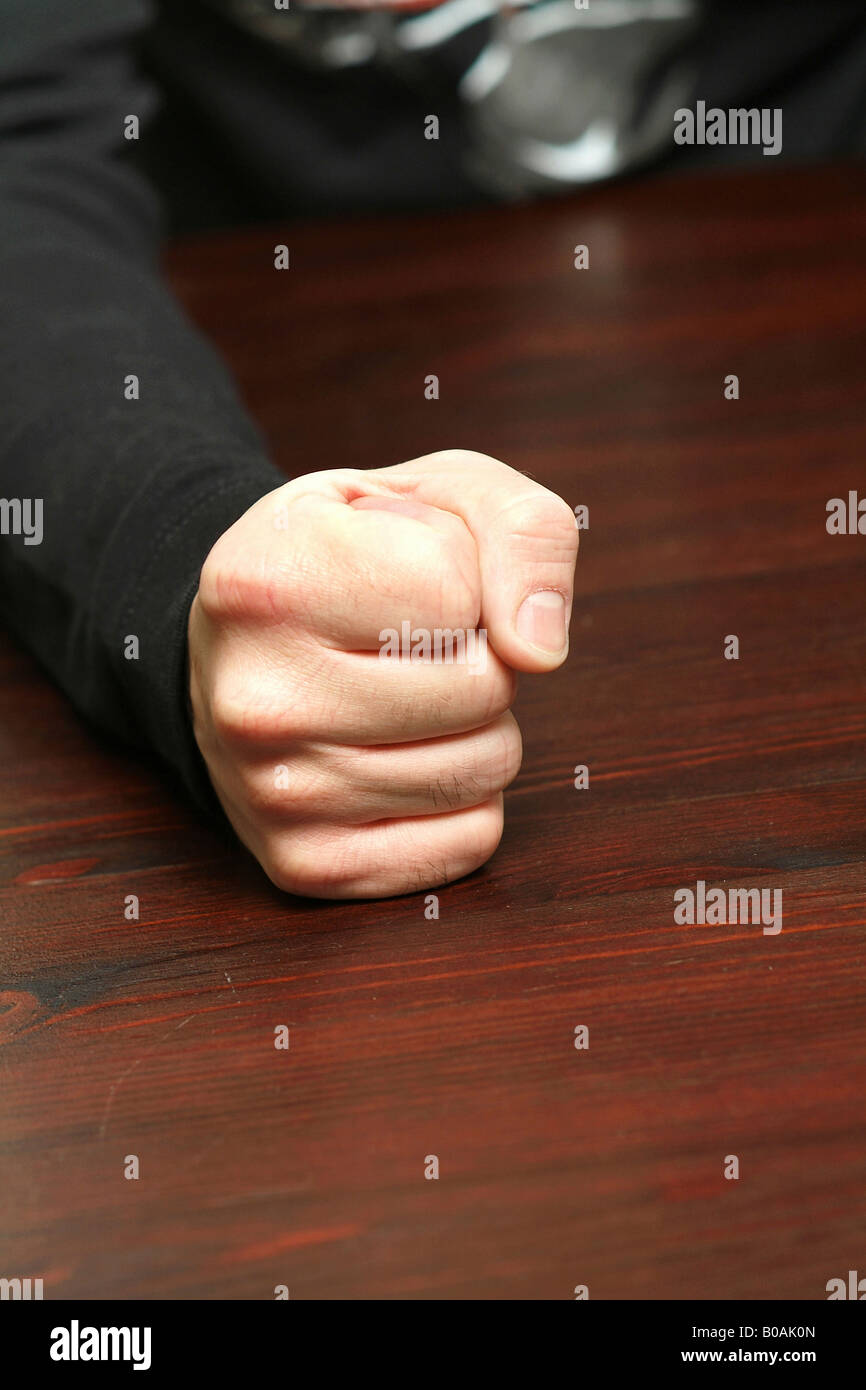 Man banging his fist on the table Stock Photo