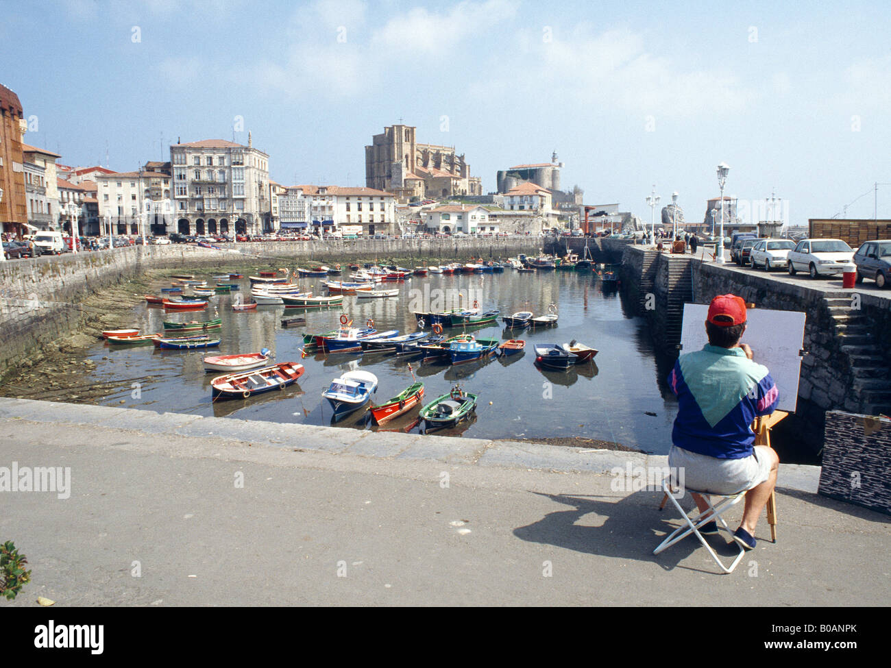 Man painting picture at the harbour. Castro Urdiales. Cantabria province. Spain. Stock Photo