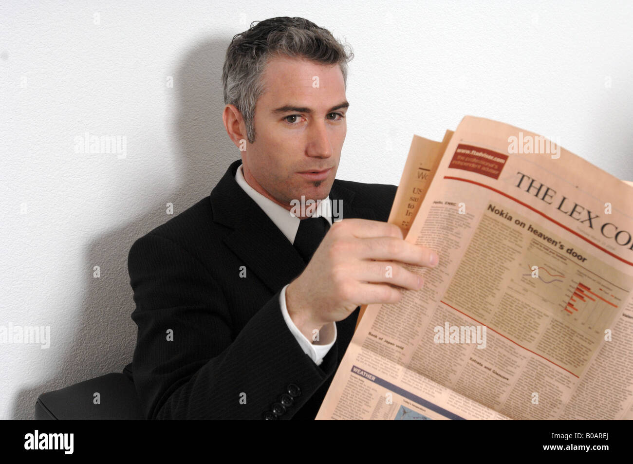man reading newspaper Stock Photo
