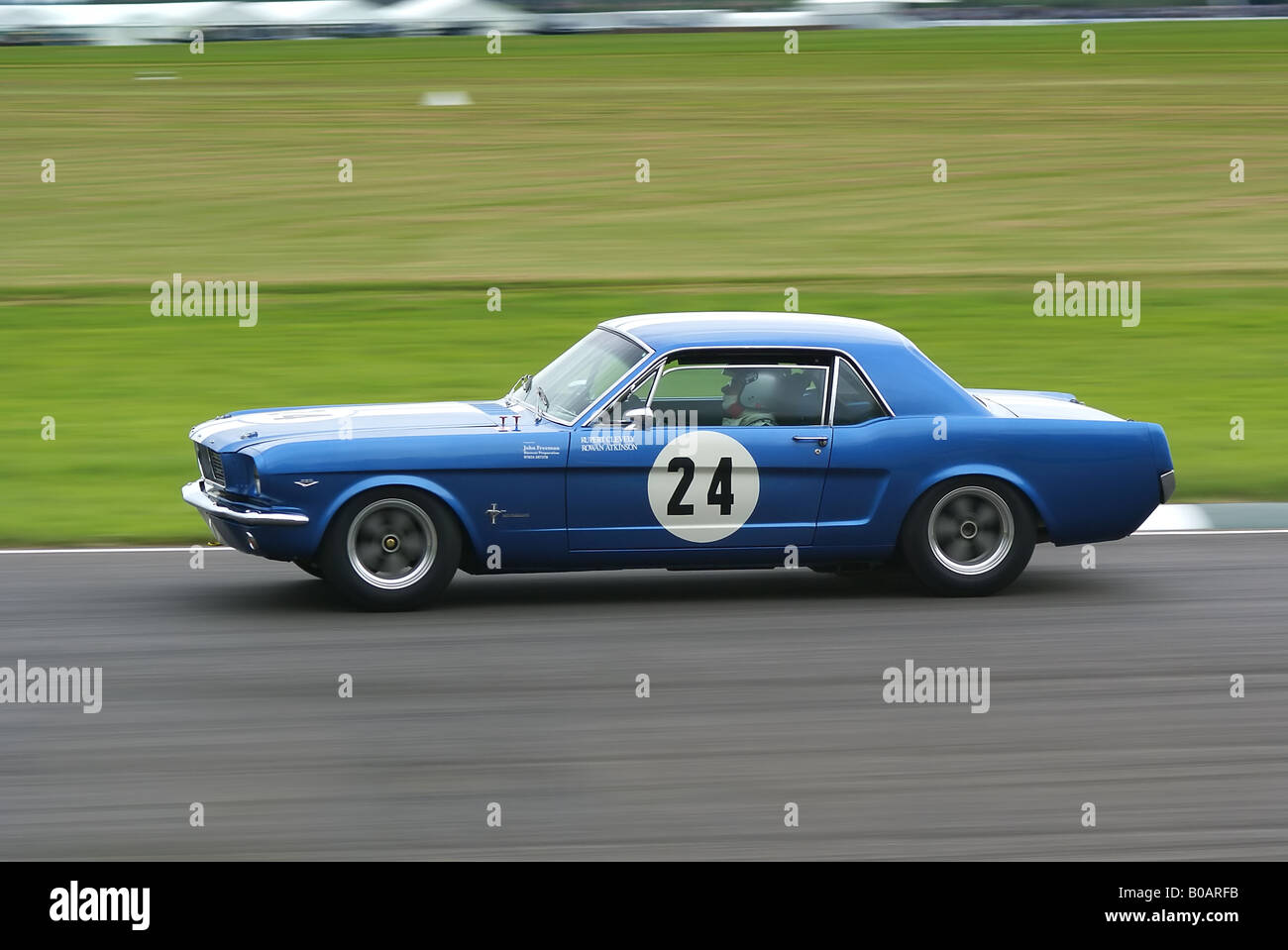 A classic Ford Mustang being driven by Rowan Atkinson Stock Photo
