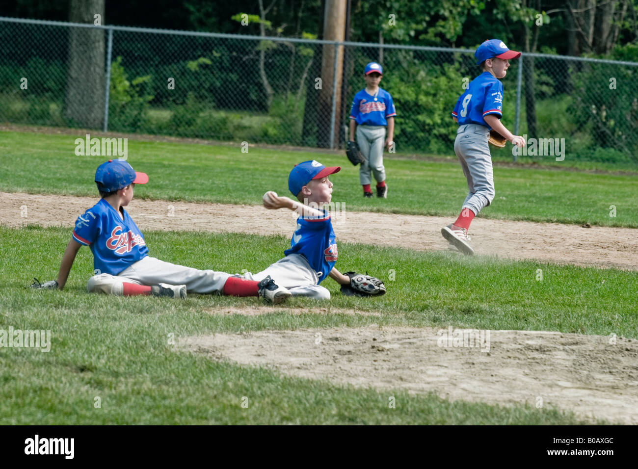 Young boy playing in the infield during a Little League baseball game