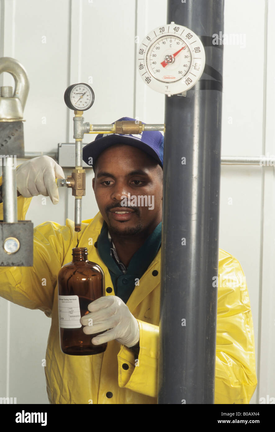 Checking chemical composition of water, purification plant, ecology, sewage, African American male Granville Ohio USA Stock Photo