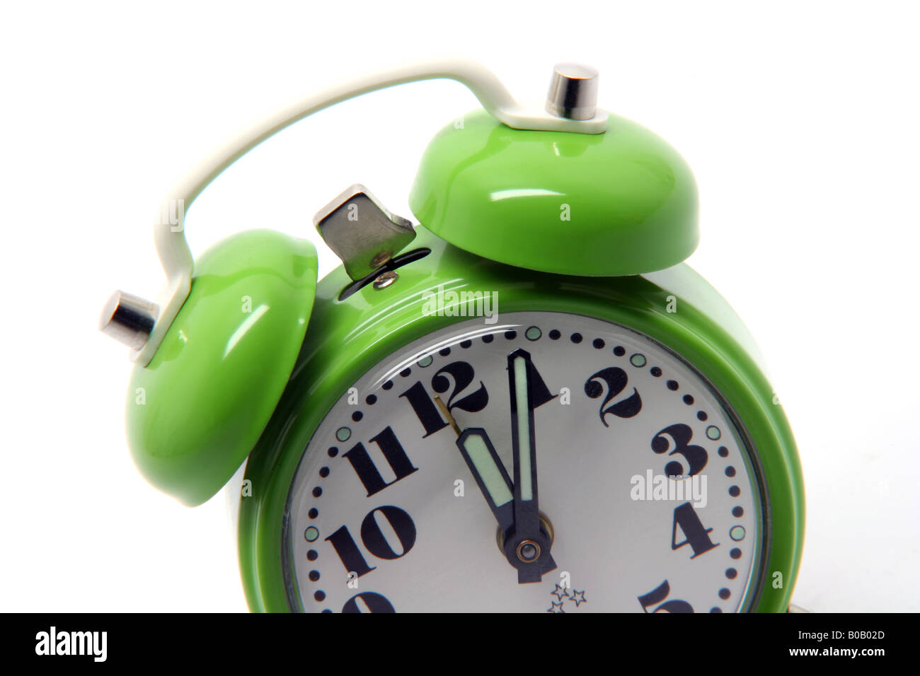 small green alarm clock at twelve oclock isolated on white background Stock Photo Alamy