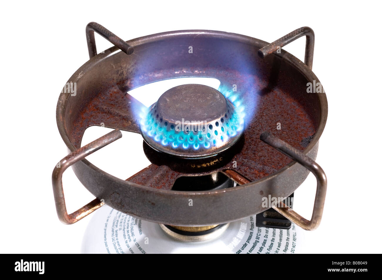 An old lit portable camping stove and gas canister Stock Photo - Alamy