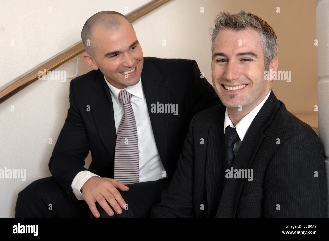 businessmen talking on the stairs Stock Photo
