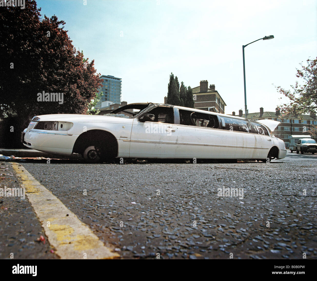 limousine burnt out in road Stock Photo