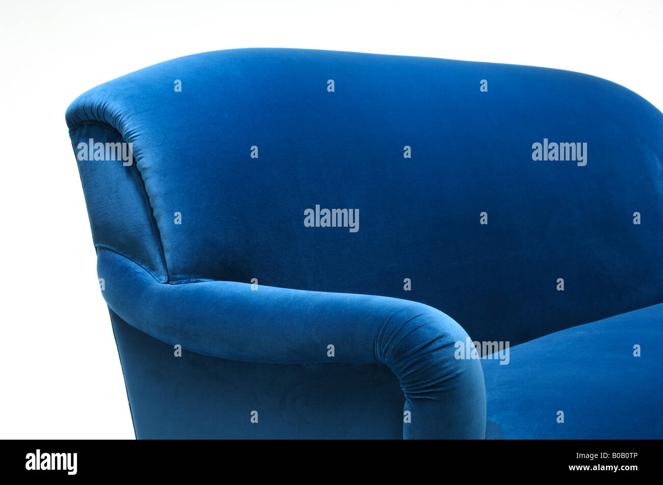 A close up section of a blue velvet sofa couch furniture Stock Photo
