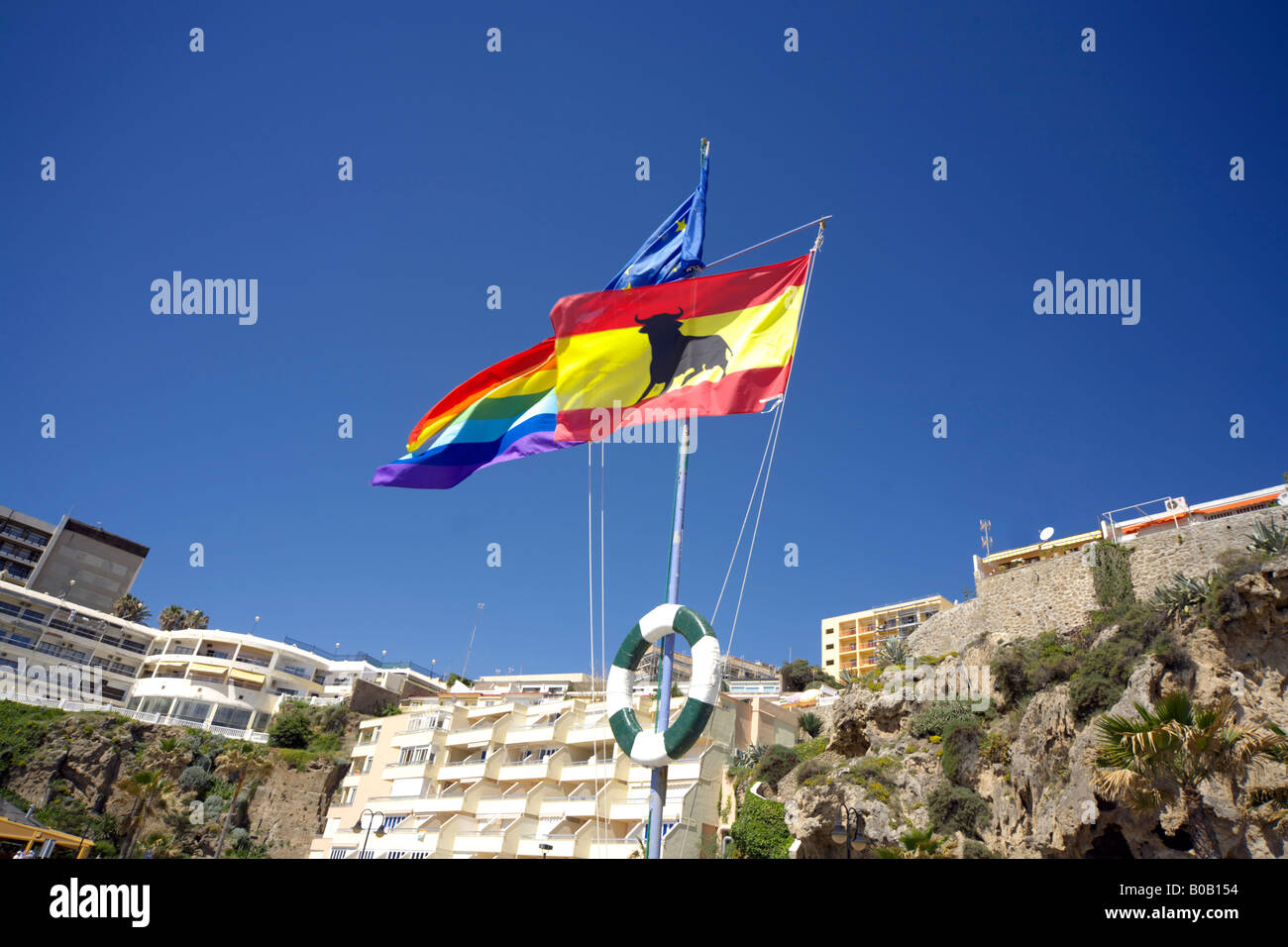 Spanish and EU flags flying on the beach at Torremolinos, Costa del Sol, Spain Stock Photo
