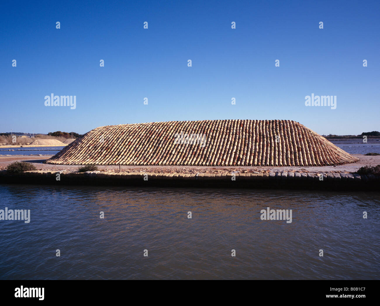 Piles of sea salt protected by terracotta tiles near Trapani or Marsala Sicily Italy EU. Stock Photo
