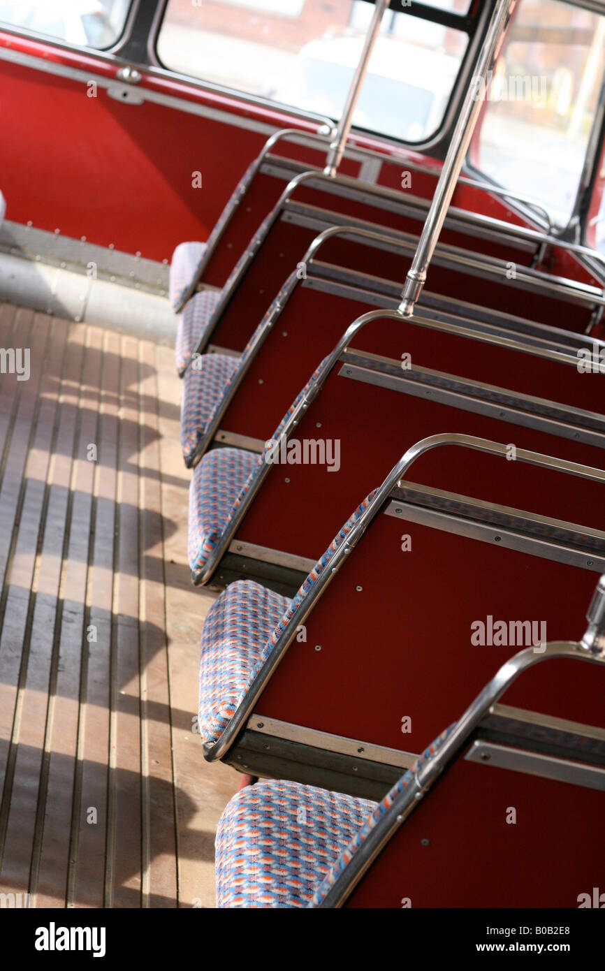Rows of Routemaster red bus seats Stock Photo
