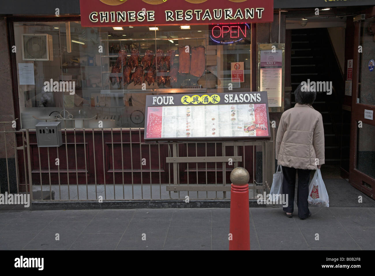 Woman Looking At Restaurant Menu Outside Display Window Chinatown High