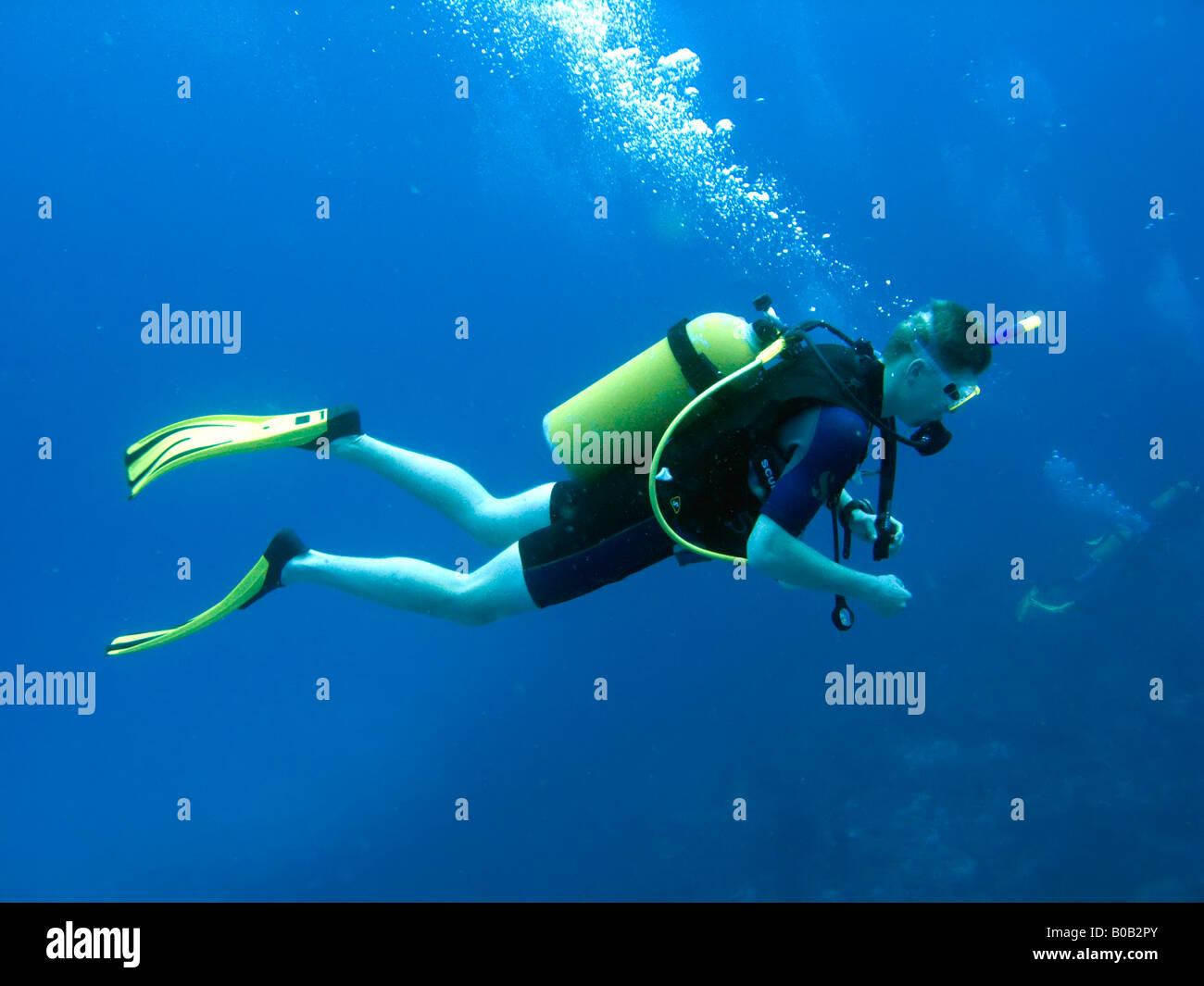 Teenage boy scuba diving in mid water Luke Hanna MR Stock Photo