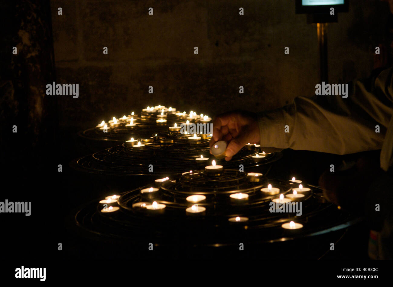 Hand lighting a candle in Notre Dame Cathedral Paris Stock Photo Alamy