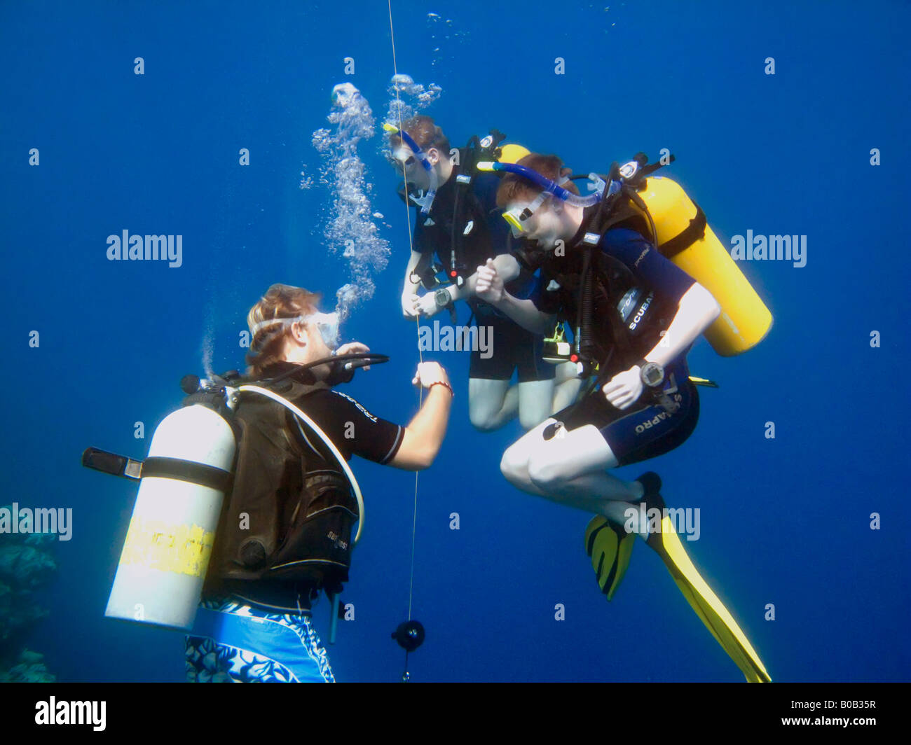 Two teenage boys scuba diving practising buoyancy control with
