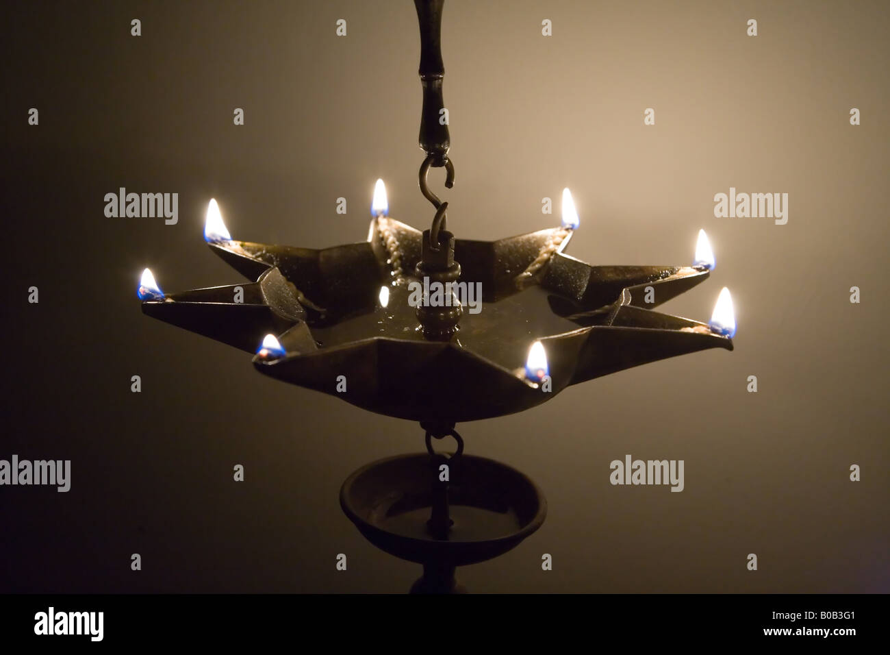 Stock photo of a eight point star antique oil lamp full of oil with