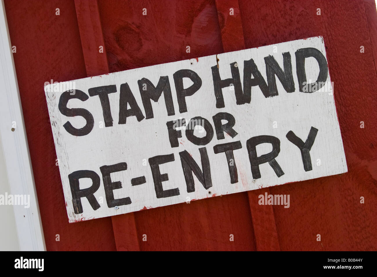 Sign at a fair reading STAMP HAND FOR RE ENTRY Stock Photo - Alamy