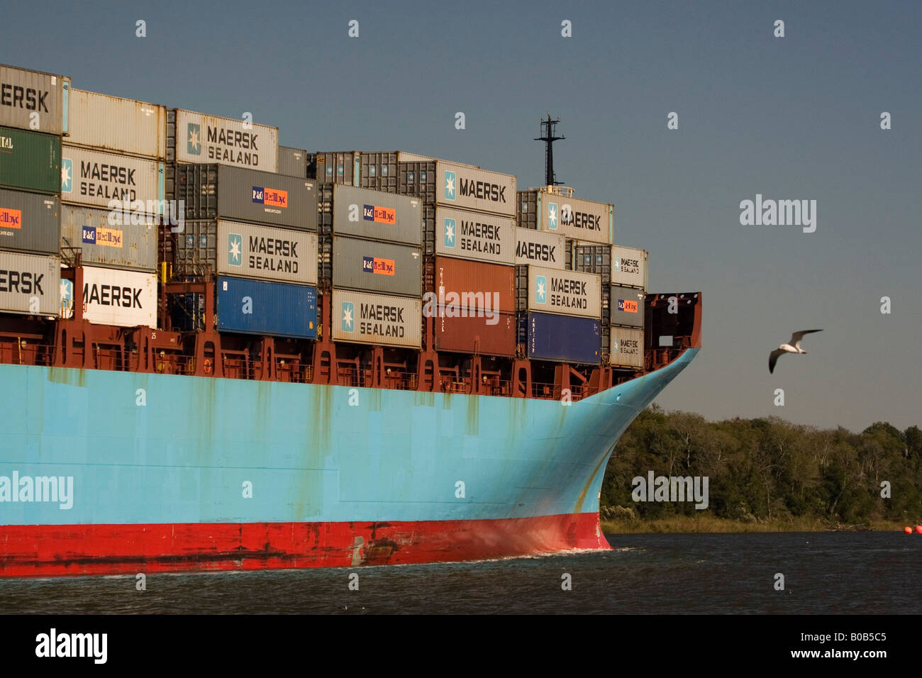 USA; Georgia: Savannah. Container ship leaving the port of Savannah ...