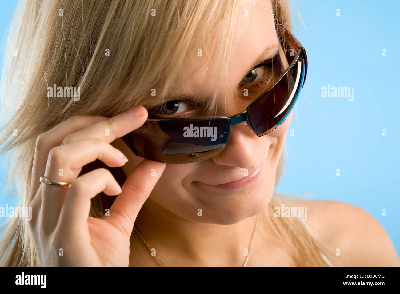 portrait of young woman on blue background Stock Photo - Alamy