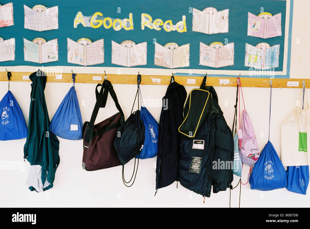school bags hanging in cloakroom Stock Photo