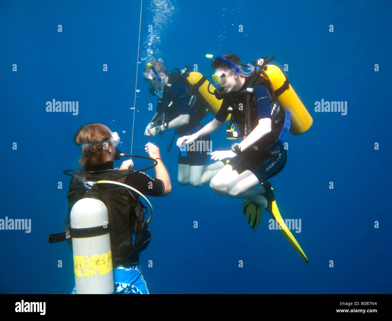 Two teenage boys scuba diving practising buoyancy control with