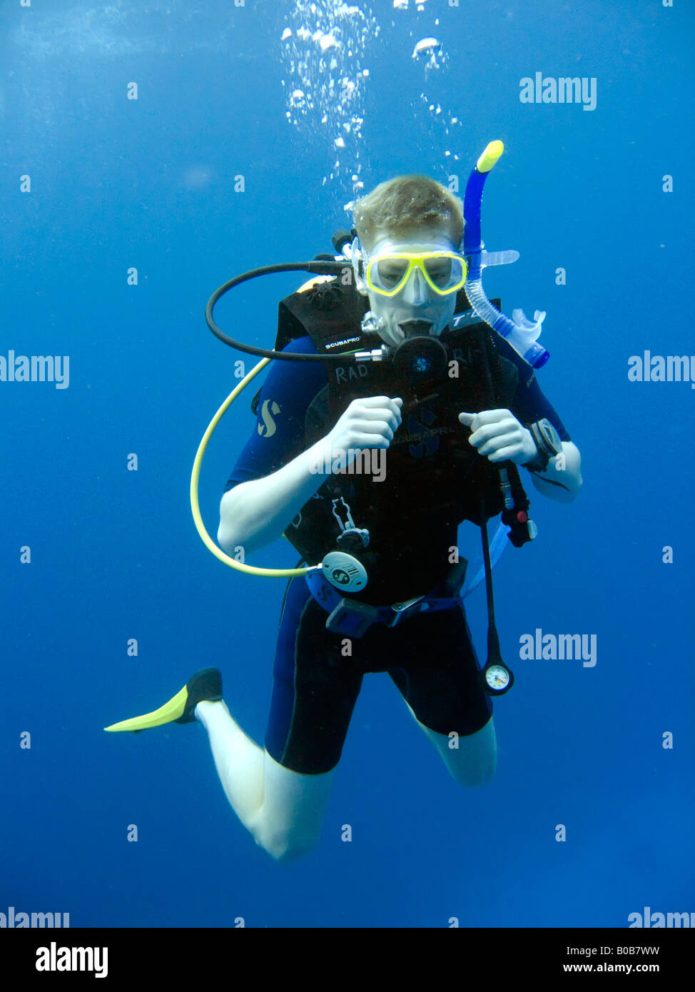 Teenage boy scuba diving in mid water Luke Hanna MR Stock Photo