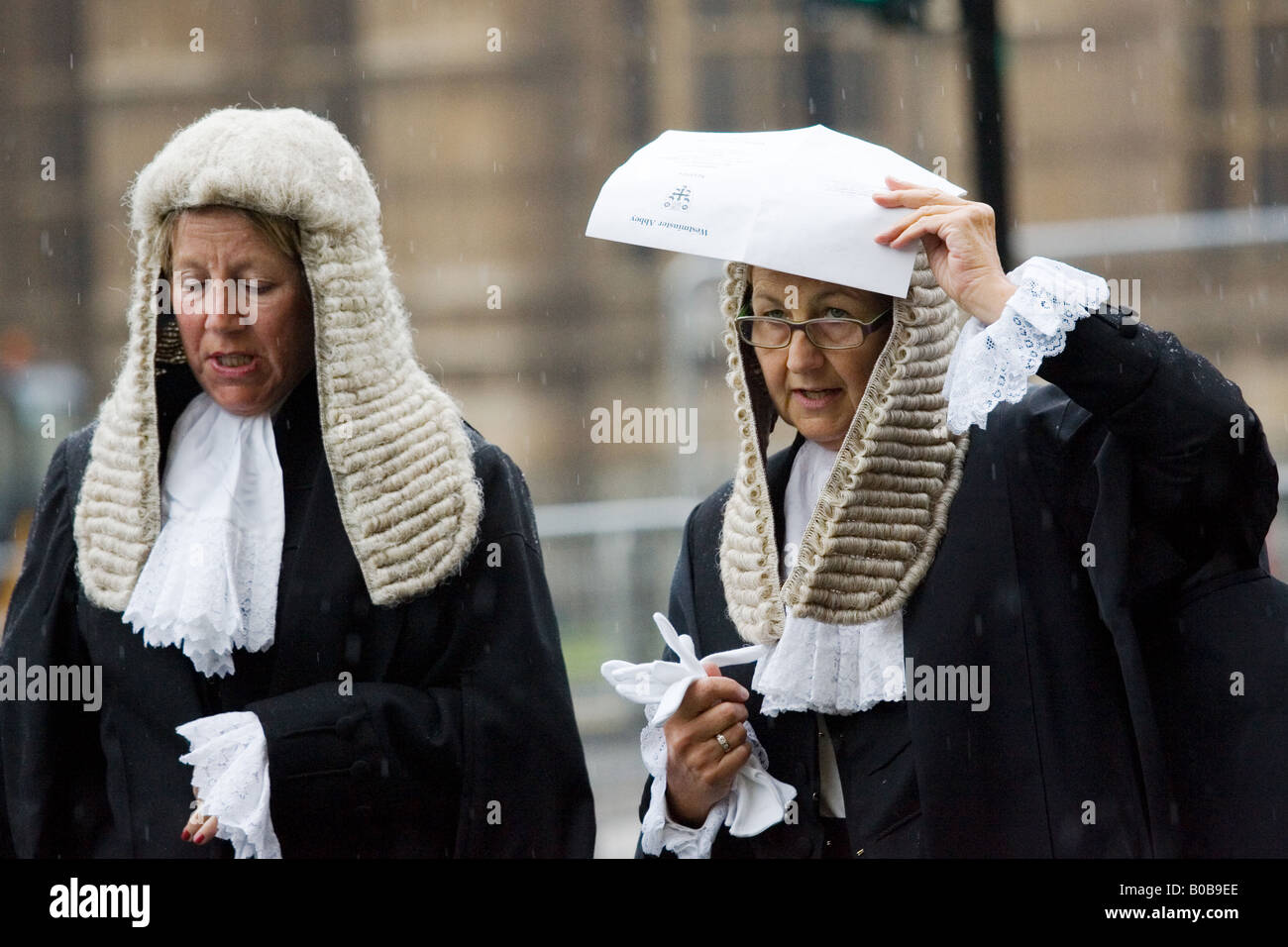 Lady Judges shelter from rain in Judges Procession from Westminster Abbey London England United Kingdom Stock Photo