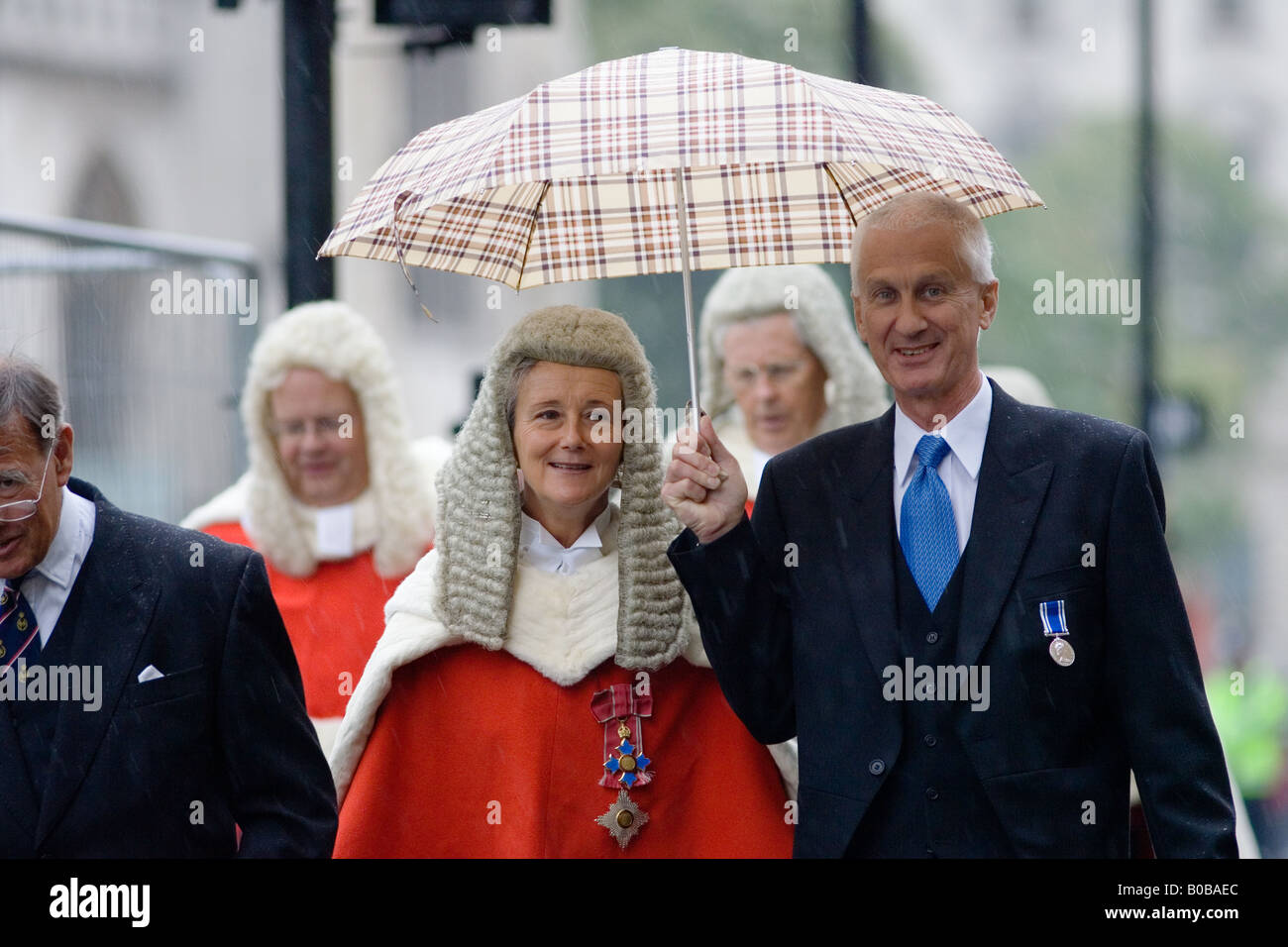 Lady judge sheltered from rain in Judges Procession from Westminster Abbey London England United Kingdom Stock Photo