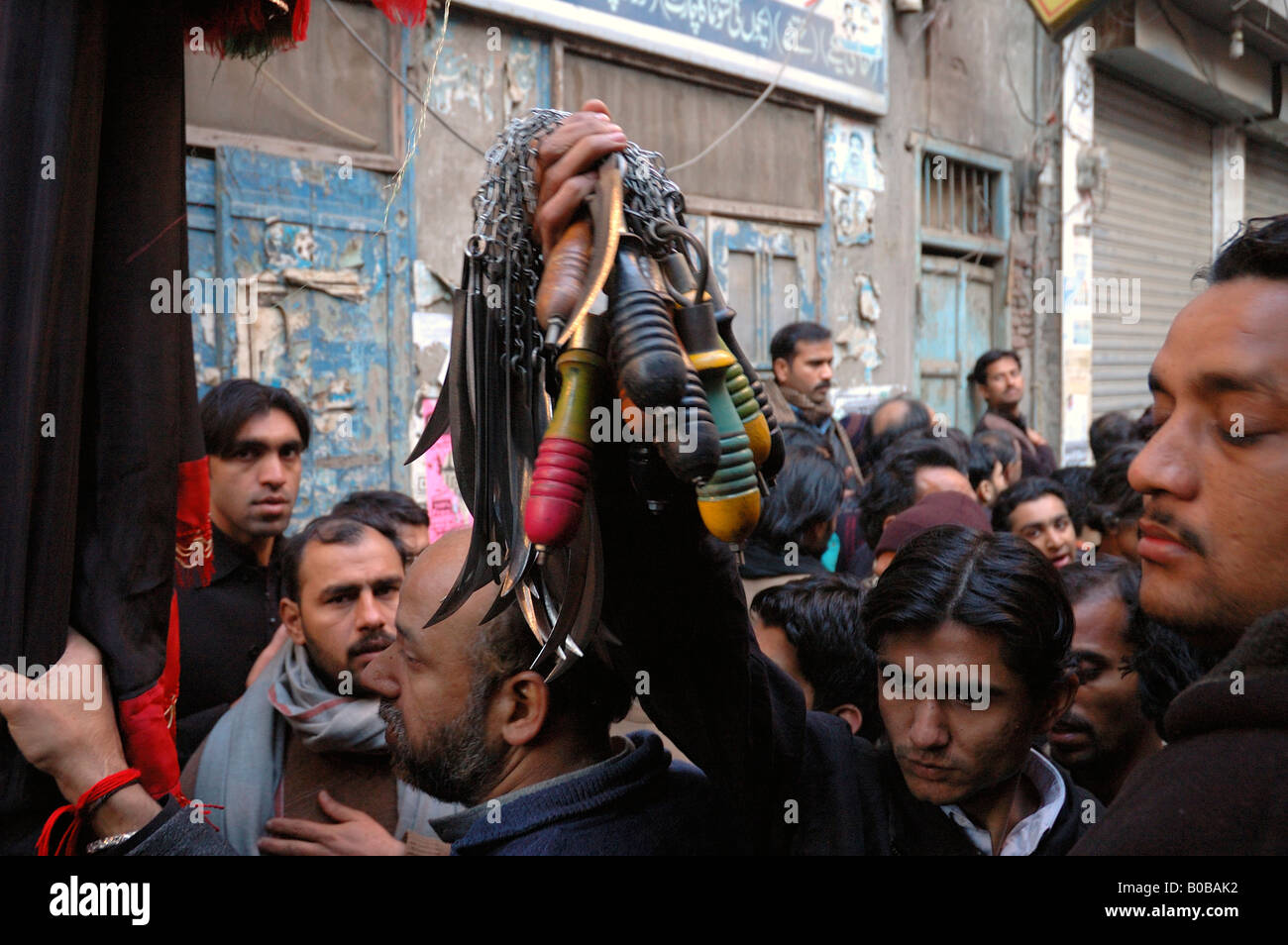 Man carrying knives for flagellation during Ashura festivities Stock
