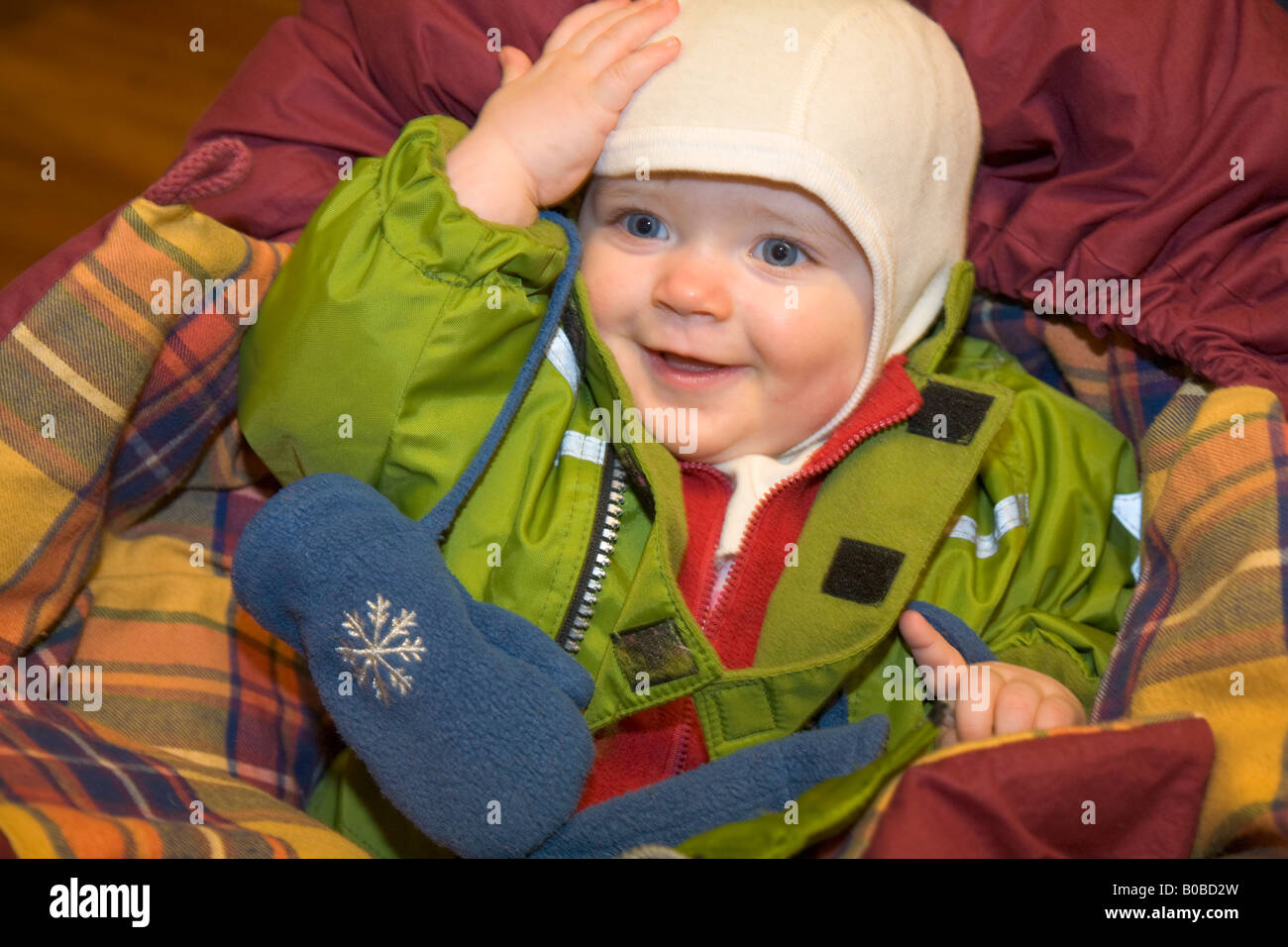 A one year old girl lying in a buggy, well protected against the cold in Kiruna / northern Sweden Stock Photo