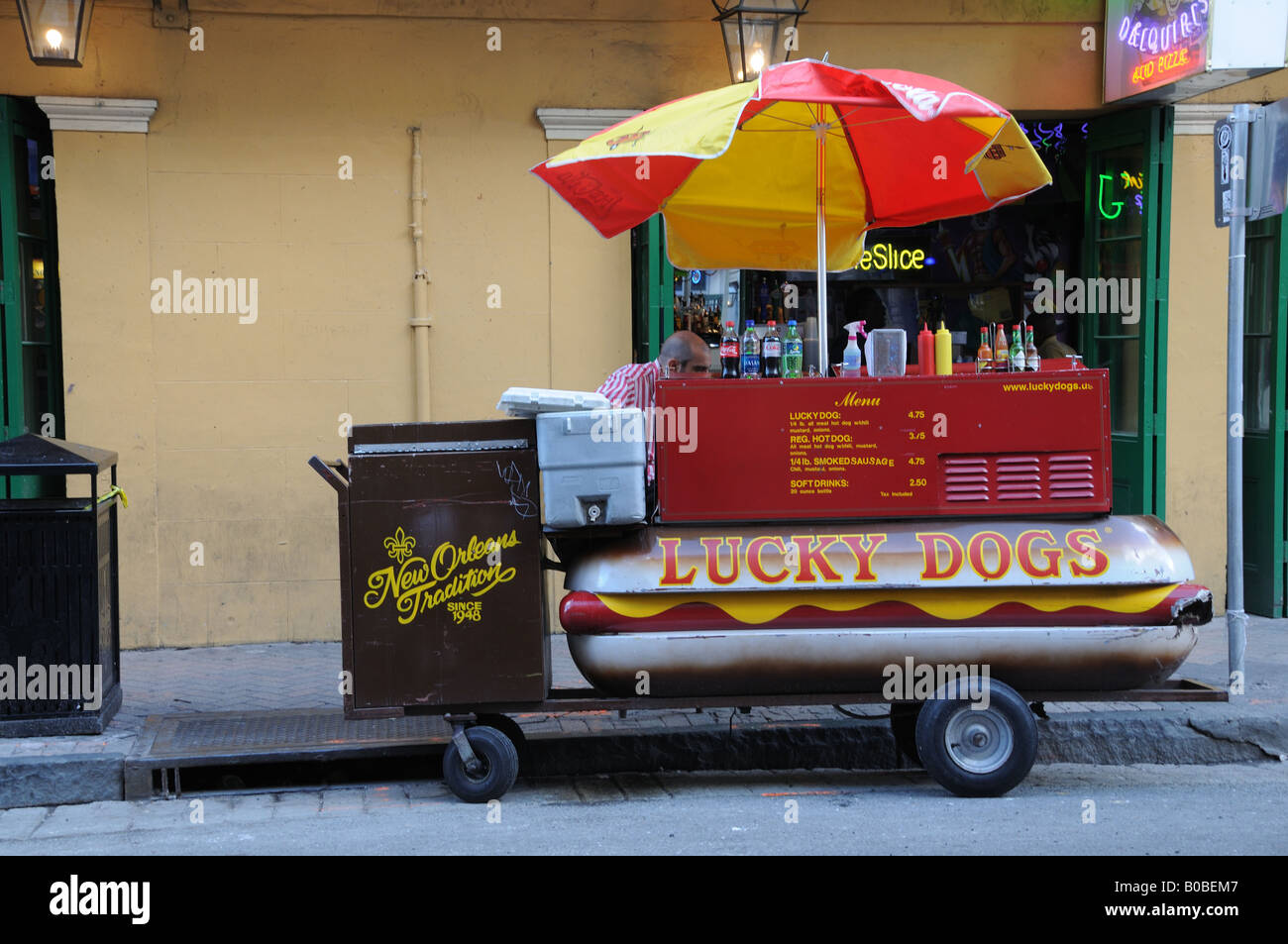 A hot dog vendor in New Orleans has parked his cart on Bourbon Street