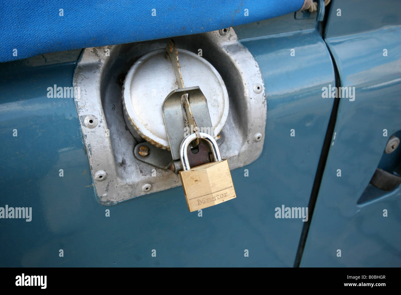 Locking fuel cap fitted to Landrover for security using standard brass padlock. Stock Photo