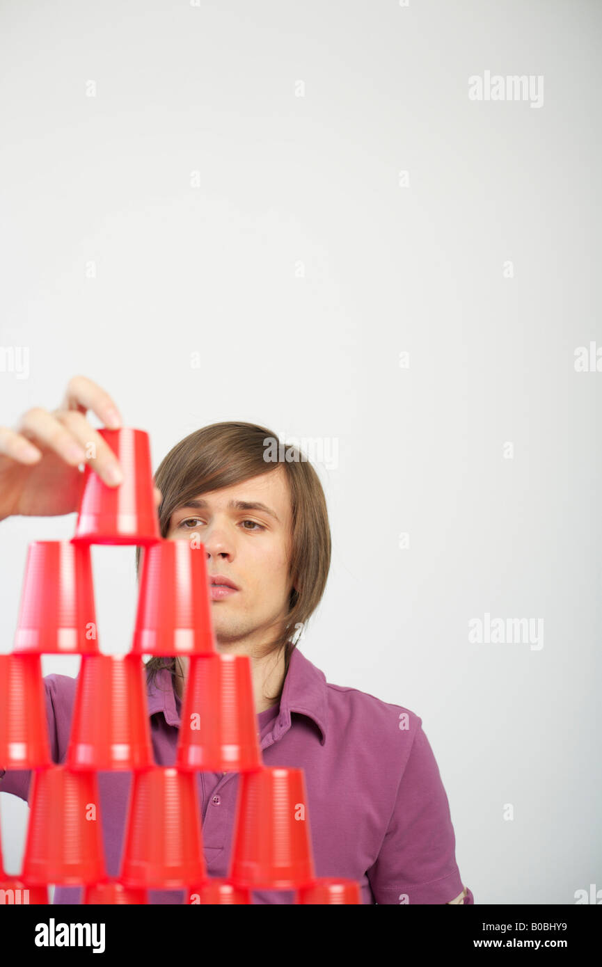 Young man stacking plastic cans Stock Photo Alamy