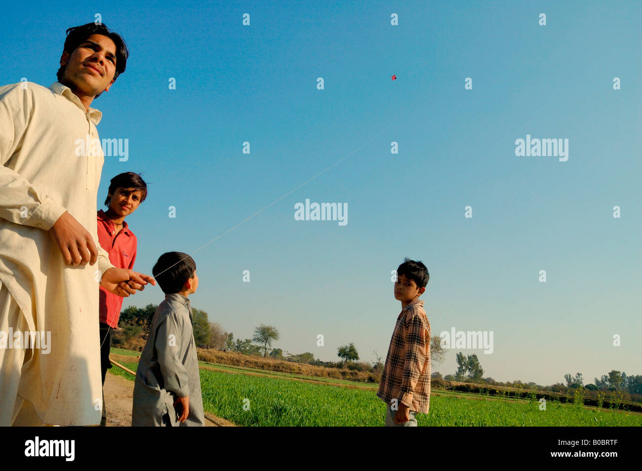 Boys flying a kite in a village near Lahore, Pakistan. Traditional
