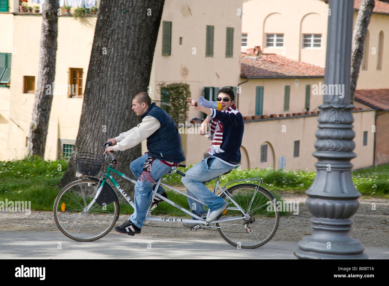 two men riding tandem on Poli bikes on the city walls of Lucca Tuscany  Italy Stock Photo - Alamy