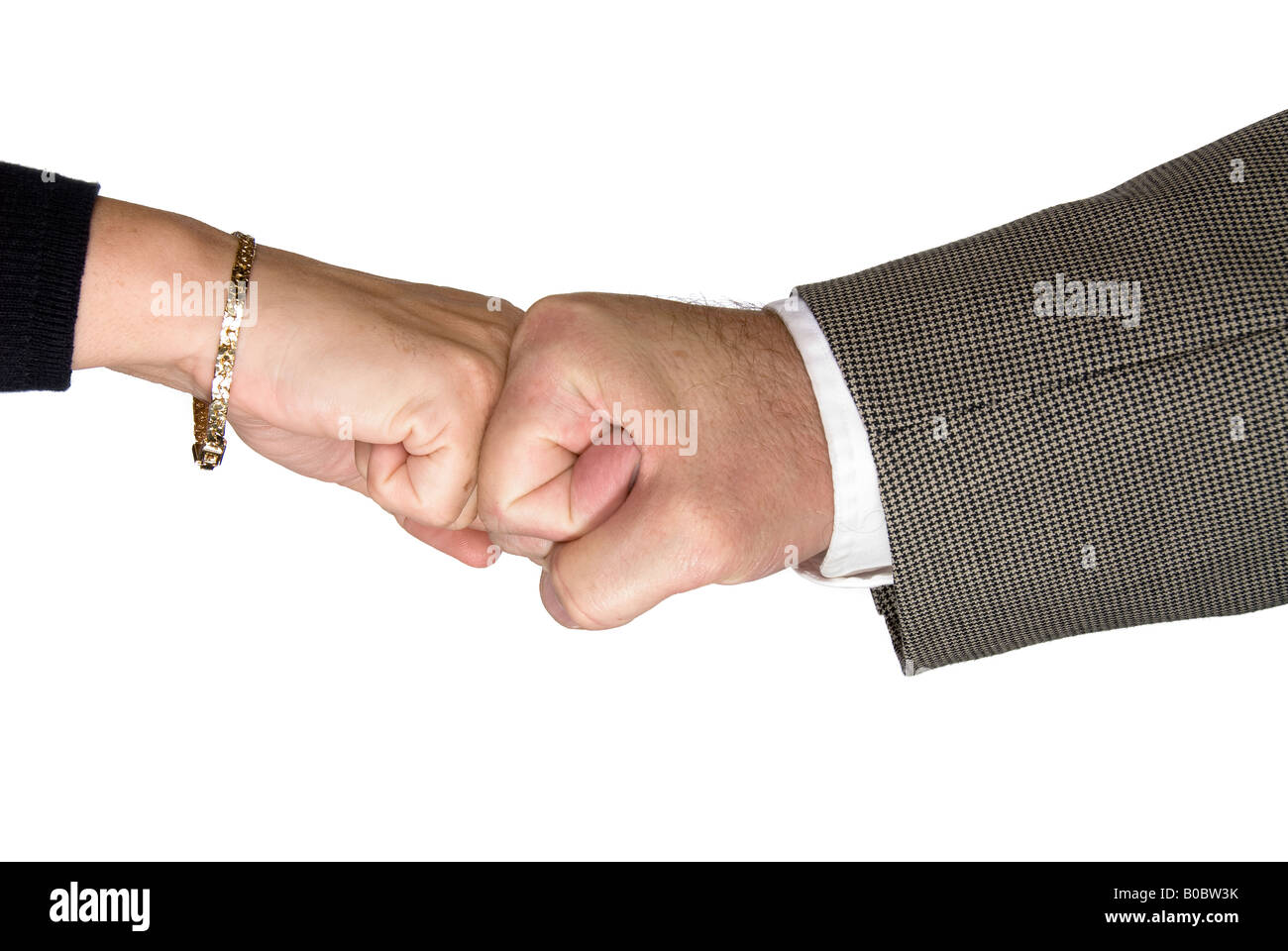 A male and female executive knock knuckles in agreement Stock Photo