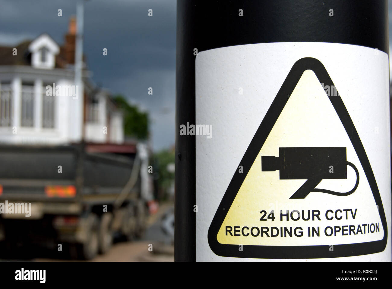 a sign warns of 24 hour cctv recording in operation, on a road junction