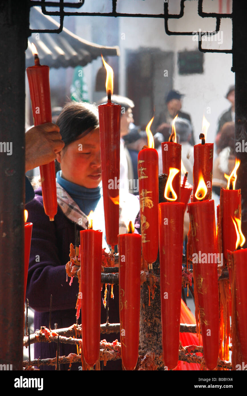 A Chinese  Buddhist woman lighting  candles  at the Hanshan or Cold Mountain Temple near Suzhou.China. Stock Photo