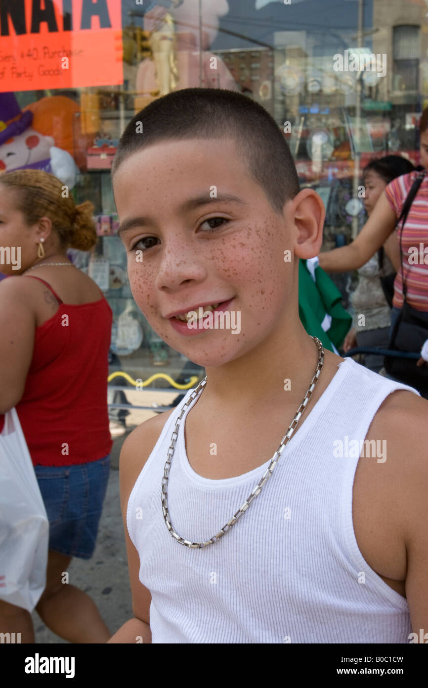 Portrait of a smiling boy with freckles at a Hispanic parade in