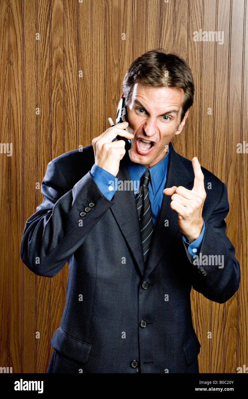 Businessman on cell phone yelling Stock Photo