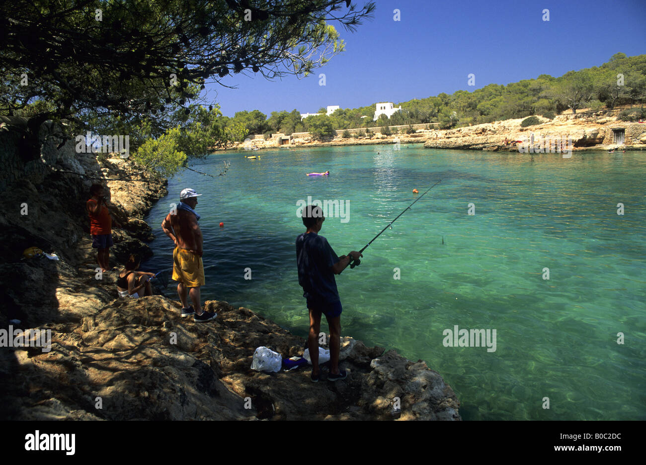Man fishing in Cala Gracio Ibiza island Balearic island Spain Stock Photo
