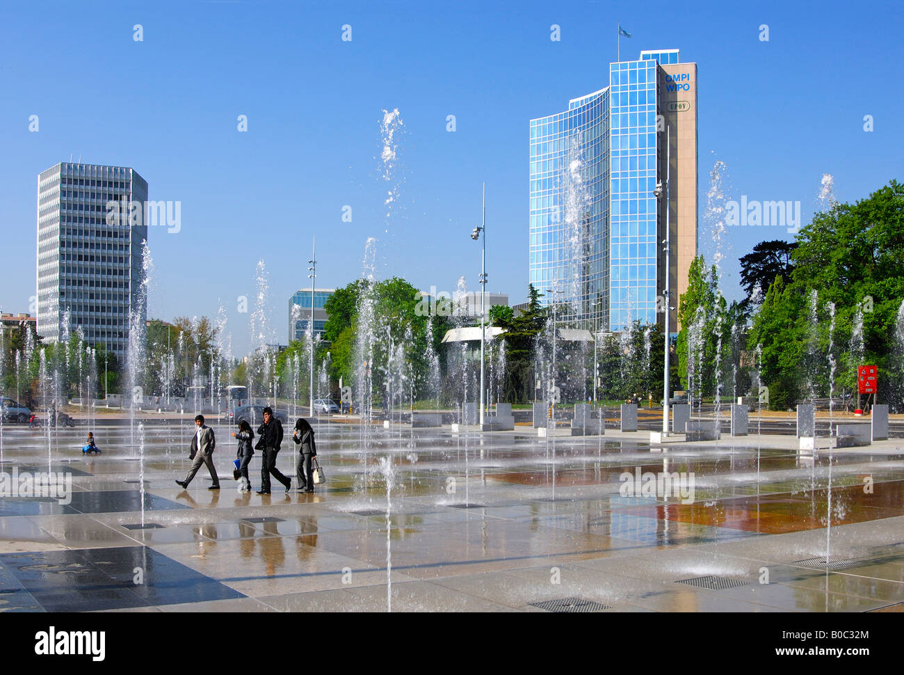 Trick fountains on Place des Nations in Geneva ITU Headquarters left WIPO UPOV buildings on the right Geneva Switzerland Stock Photo