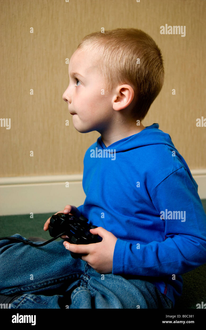 Boy holding a games console Stock Photo