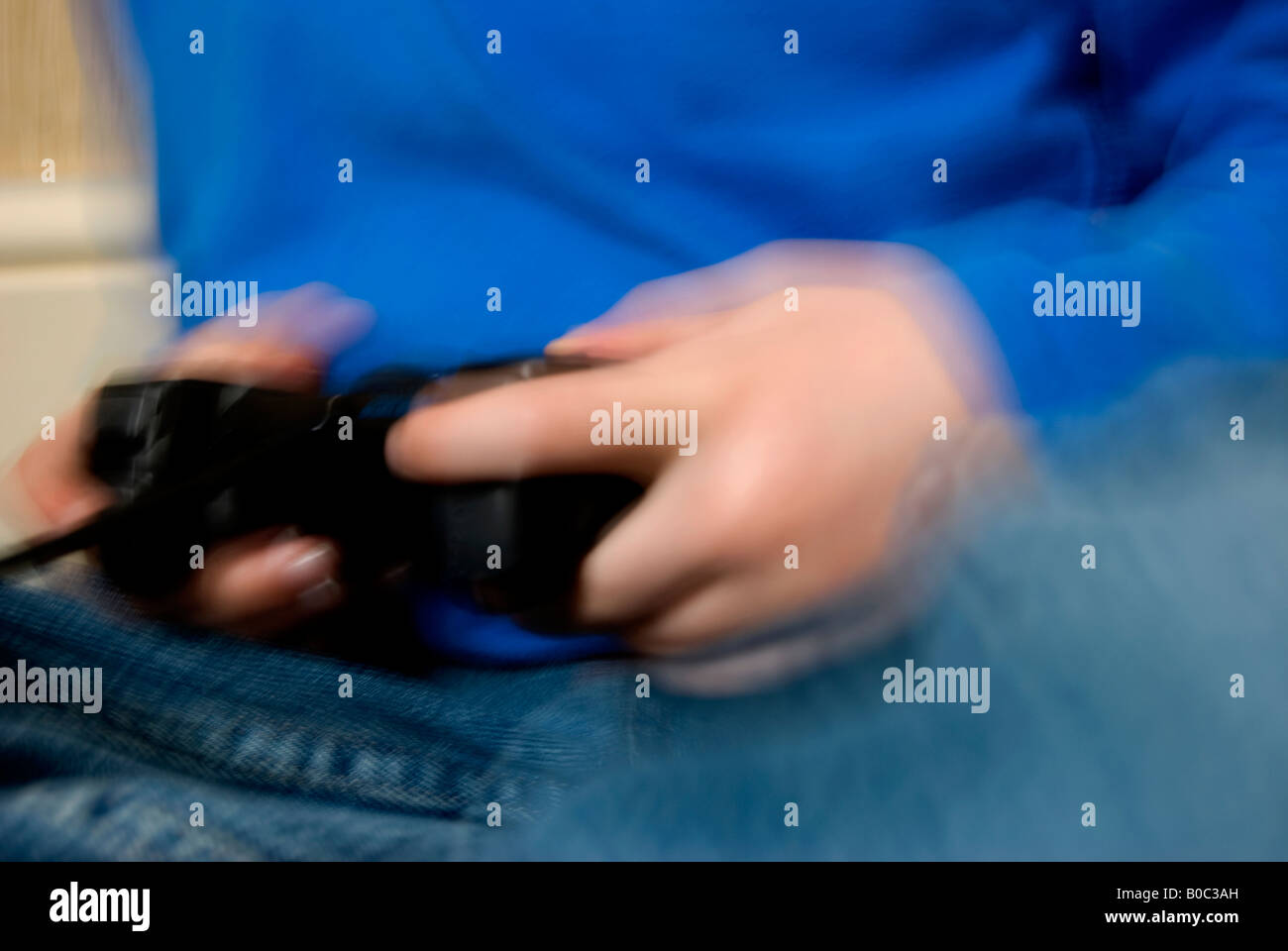 Hands holding a games console showing motion blur Stock Photo