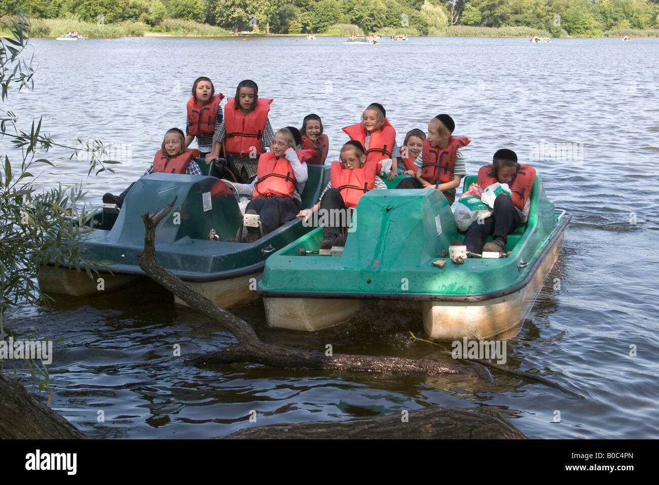 Orthodox Jewish boys on paddle boats in the lake in Prospect Park