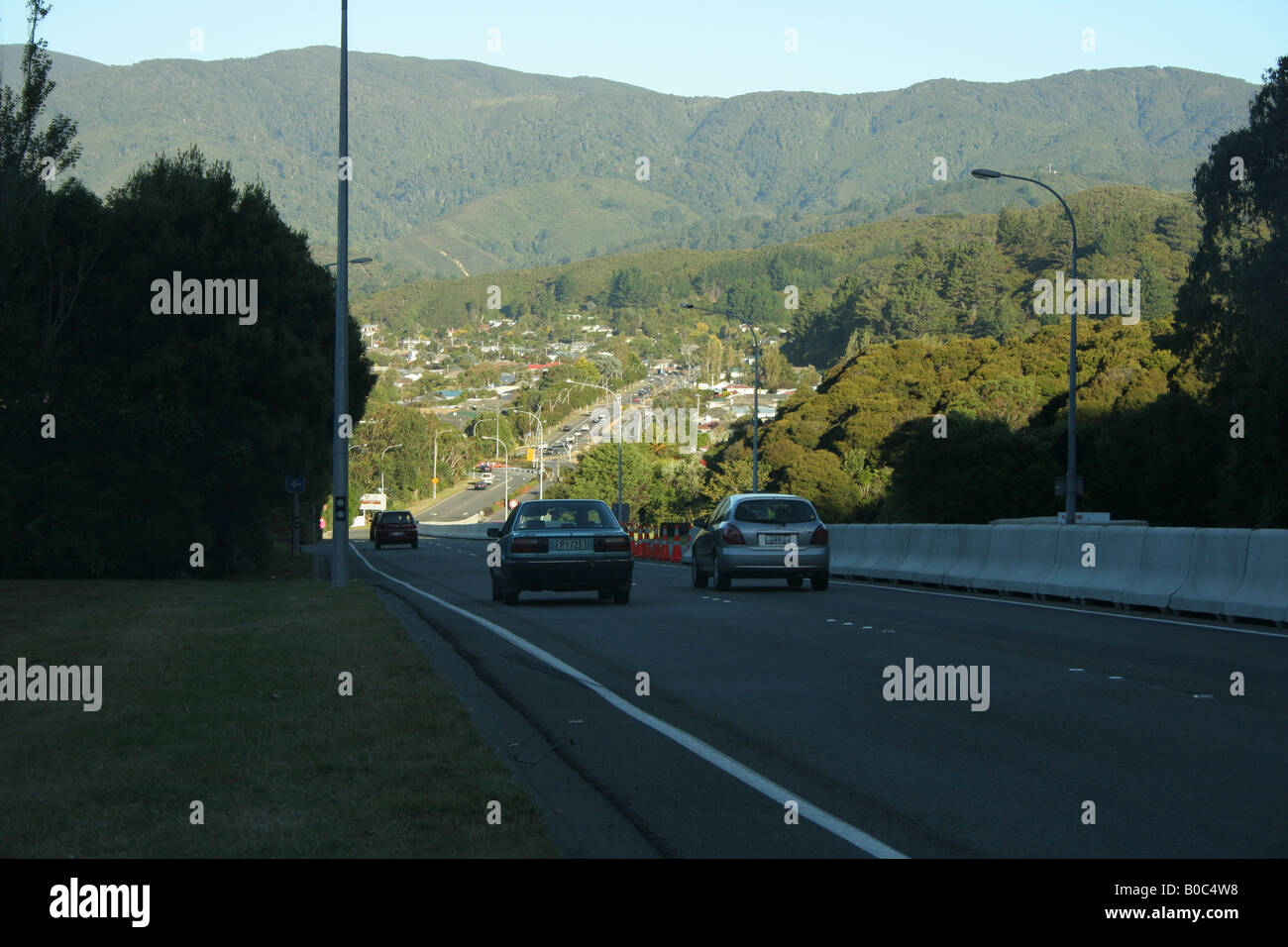 Cars travelling down a road into the Wainuiomata valley Stock Photo Alamy
