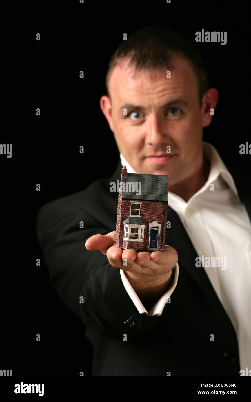 "man holding a model house Stock Photo - Alamy