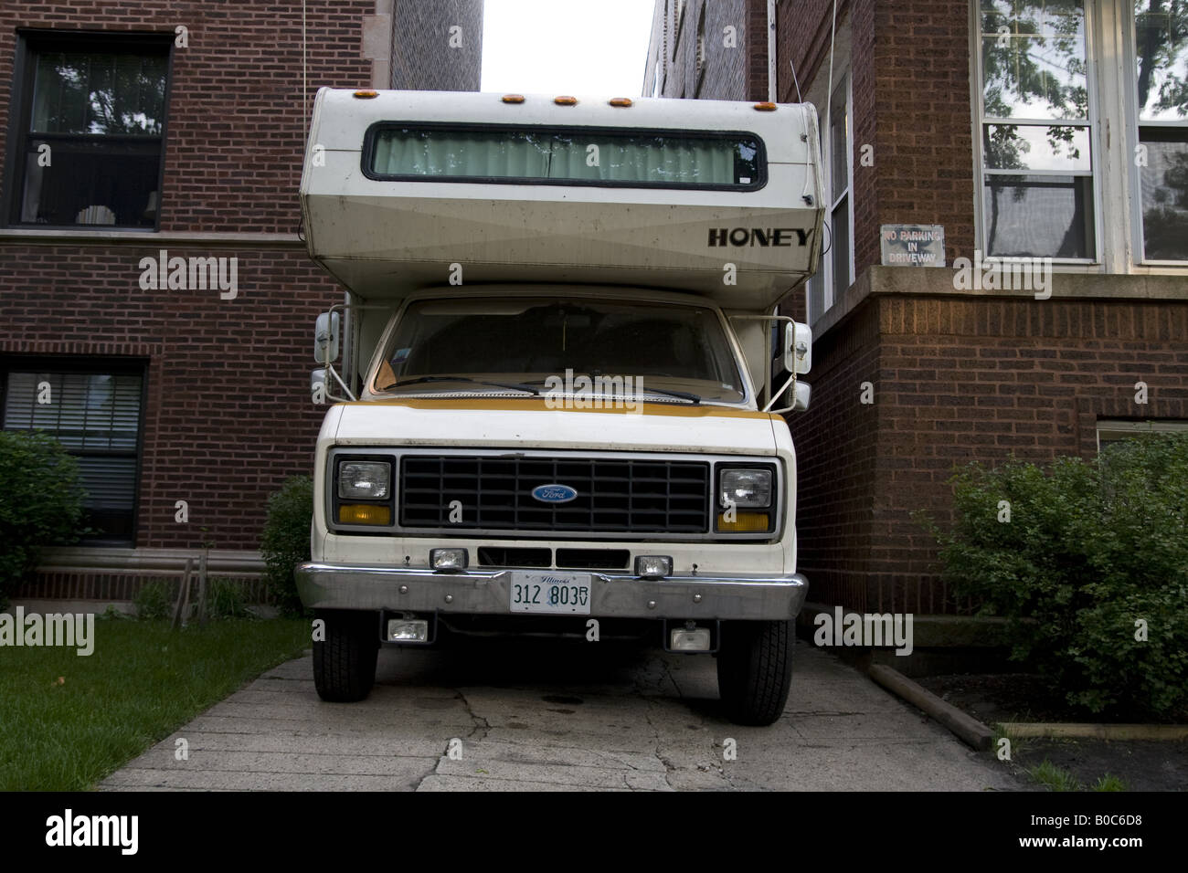Ford camper van with a top wedged bewteen two apartment buildings Chicago IL Stock Photo