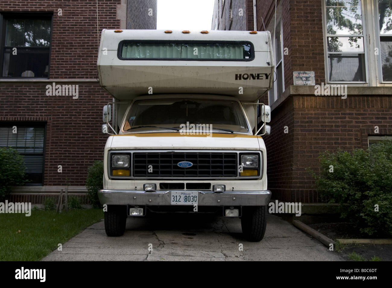 Ford camper van with a top wedged bewteen two apartment buildings Chicago IL Stock Photo
