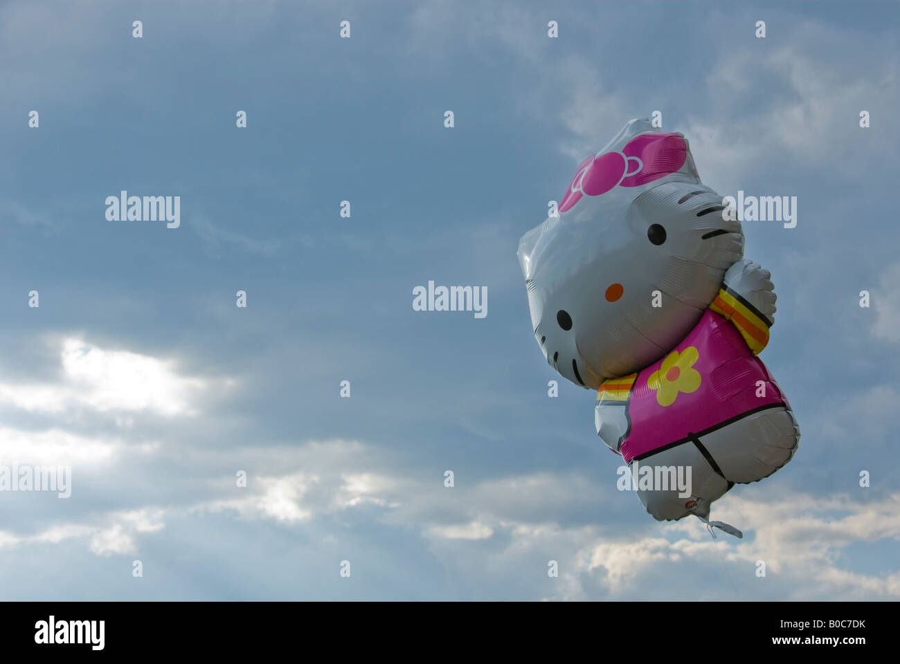 A hello kitty helium balloon against cloudy sky Stock Photo
